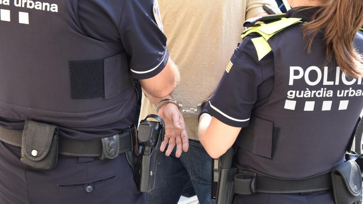 Agentes de la Guardia Urbana de Barcelona detienen a un individuo