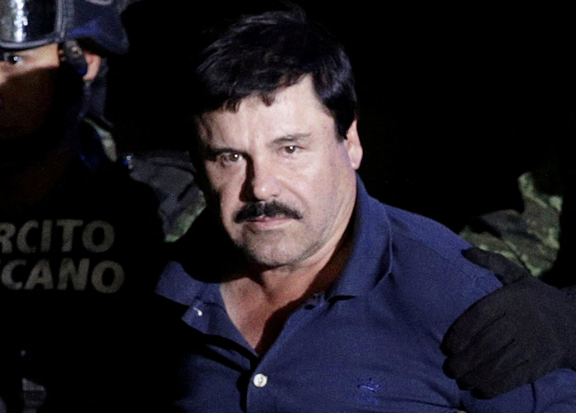 FILE PHOTO: FILE PHOTO: Recaptured drug lord Joaquin &quot;El Chapo&quot; Guzman is escorted by soldiers at the hangar belonging to the office of the Attorney General in Mexico City