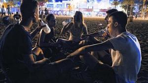 ESCENES DE ’BOTELLON’.  Els llauners tempten el públic que fa cua per entrar als clubs de Marina Village. I els joves s’instal·len en diferents punts de les platges per beure i divertir-se per pocs diners o per fer la primera copa de la nit després de proveir-se  en súpers de la Barceloneta o comprant a llauners que ocupen la zona.