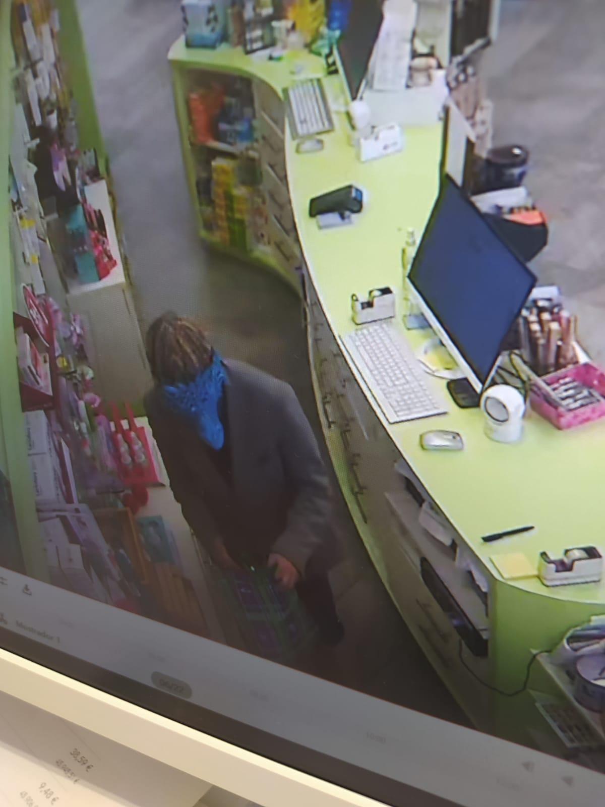 El atracador, durante el robo, en una imagen captada dentro de la farmacia asaltada.