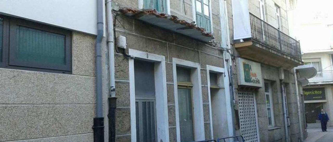 Uno de los balcones semiderruidos y las vallas colocadas, supuestamente por precaución.  // Muñiz