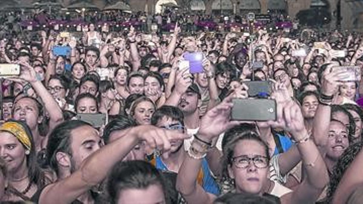 Espectadores fotografiando el concierto de Calle 13 en el Poble Espanyol, en junio.