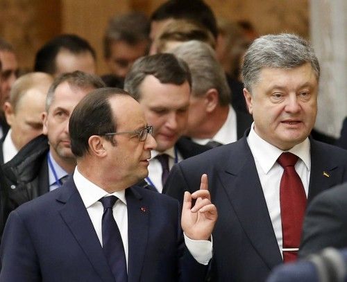 Ukraine's President Petro Poroshenko and France's President Francois Hollande speak while walking during peace talks in Minsk