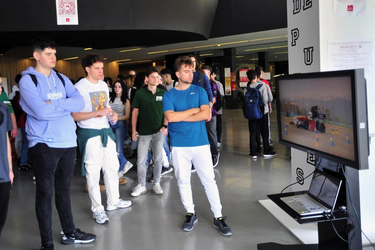 Estudiantes observan un coche de Fórmula Student como el que diseñarán los alumnos de Ingeniería de la UMH
