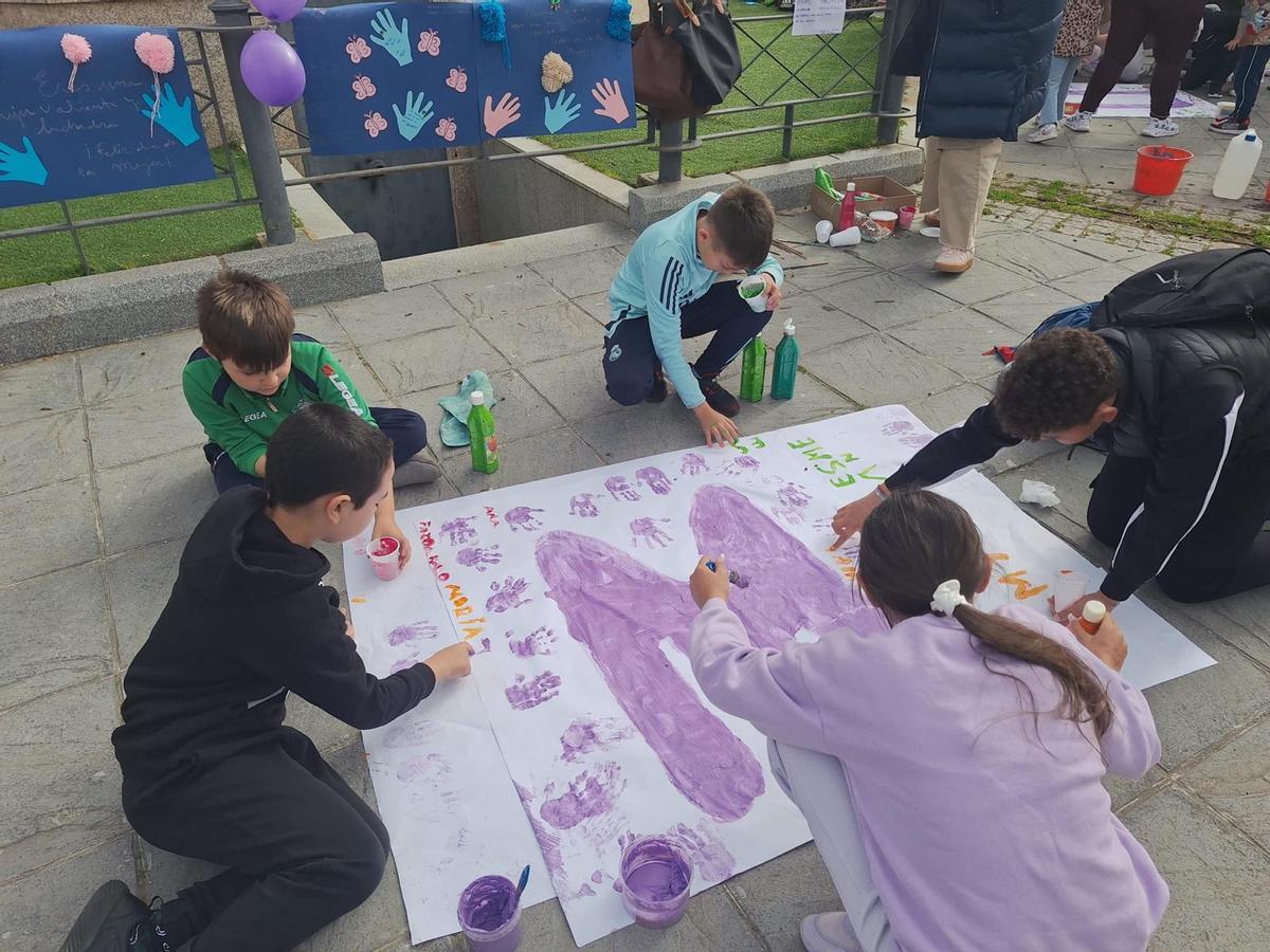FOTOS | Alumnos de los colegios Cerro de Reyes y Pastor Sito pintan de violeta el barrio por el 8M