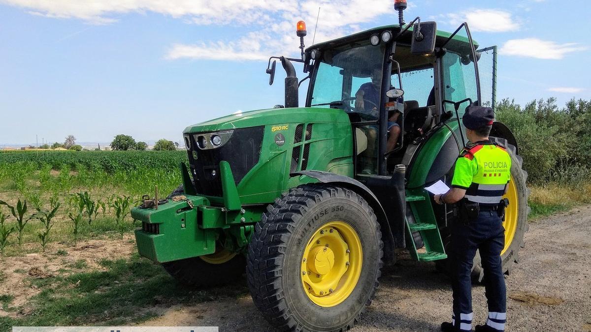 Un mosso junto a un tractor