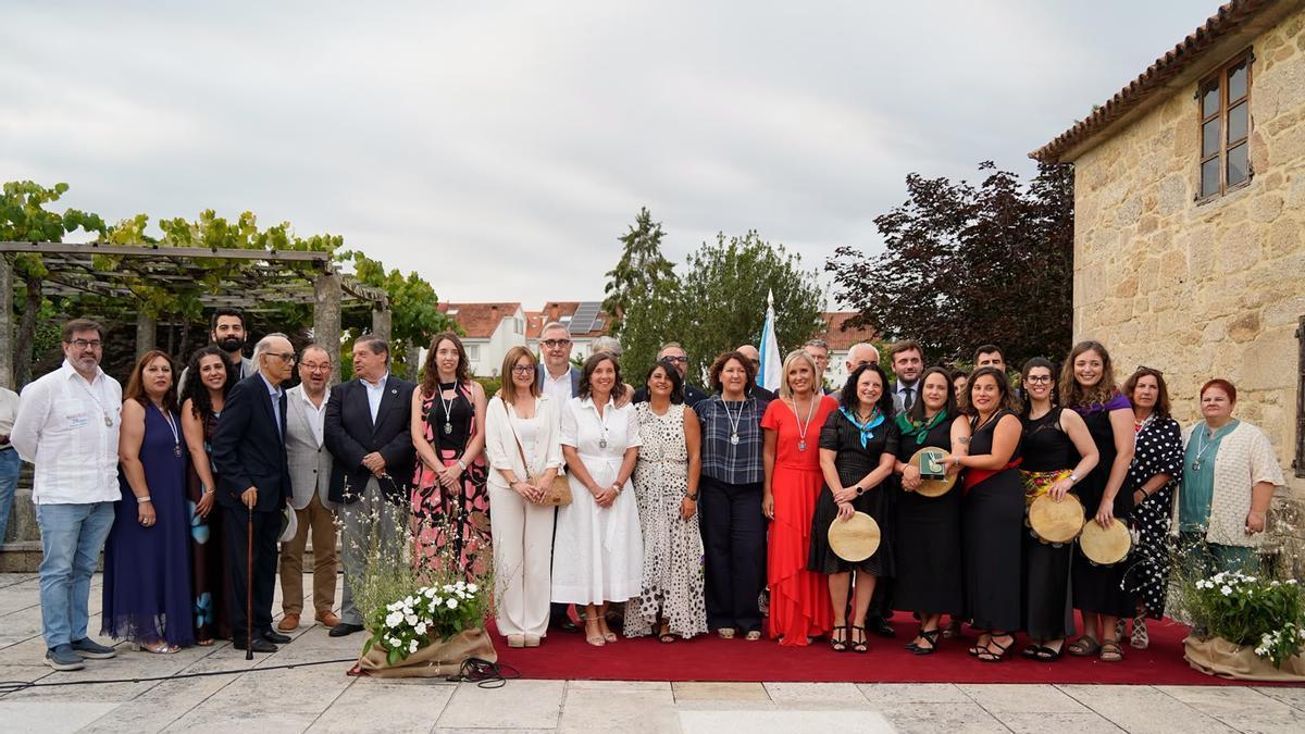 Maianas, con miembros de la Corporación municipal de Ames y homenajeados con la Medalla de Ames en ediciones anteriores.