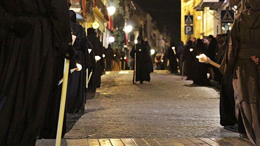 Hermanos del Sepulcro por las calles de Aguilar en Viernes Santo.