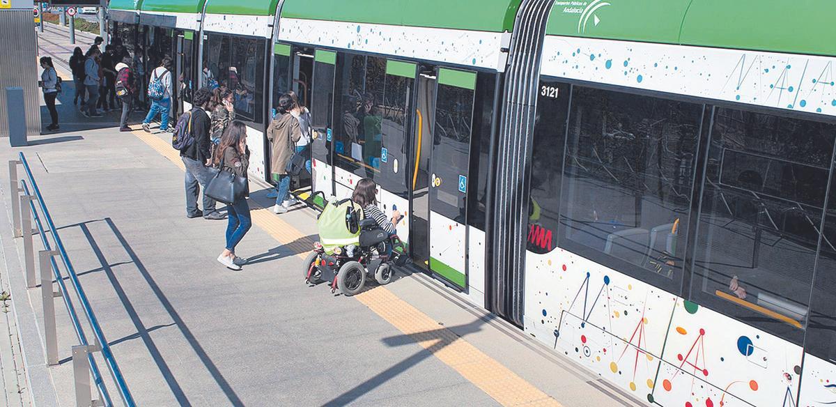 Jóvenes se suben al metro en la Universidad de Málaga.