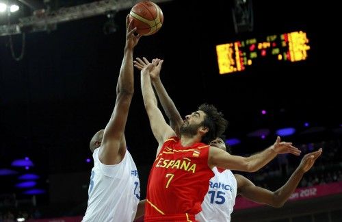 Spain's Navarro has his shot blocked by France's Diaw and Gelabale during their men's quarterfinal basketball match at the North Greenwich Arena in London during the London 2012 Olympic Games
