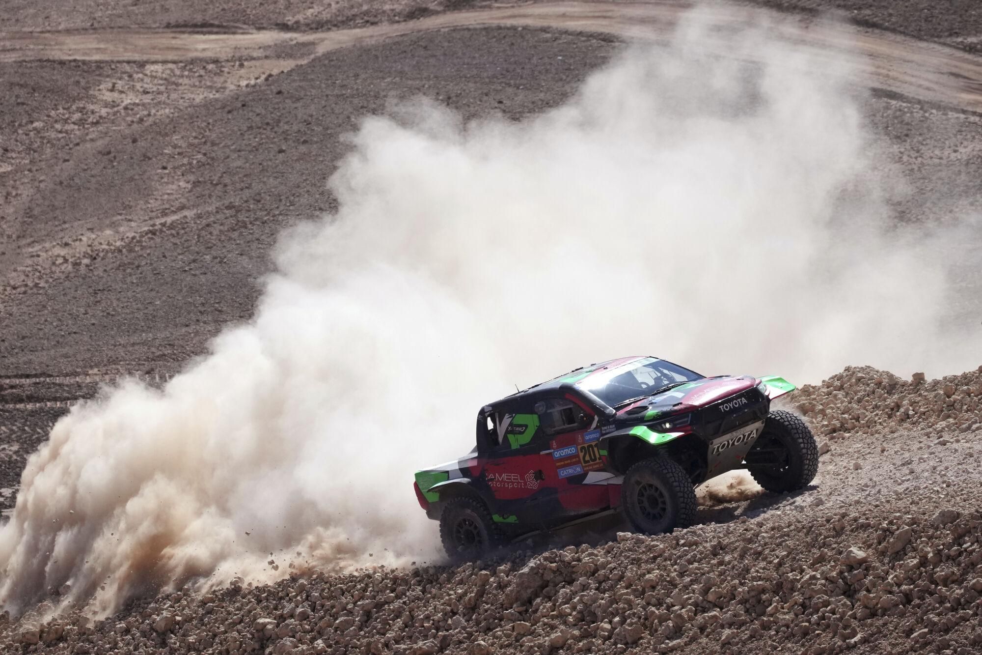 Driver Yazeed Al Rajhi and co-driver Timo Gottschalk compete during the ninth stage of the Dakar Rally between Riyadh and Haradh, Saudi Arabia, Tuesday, Jan. 14, 2025. (AP Photo/Christophe Ena)
