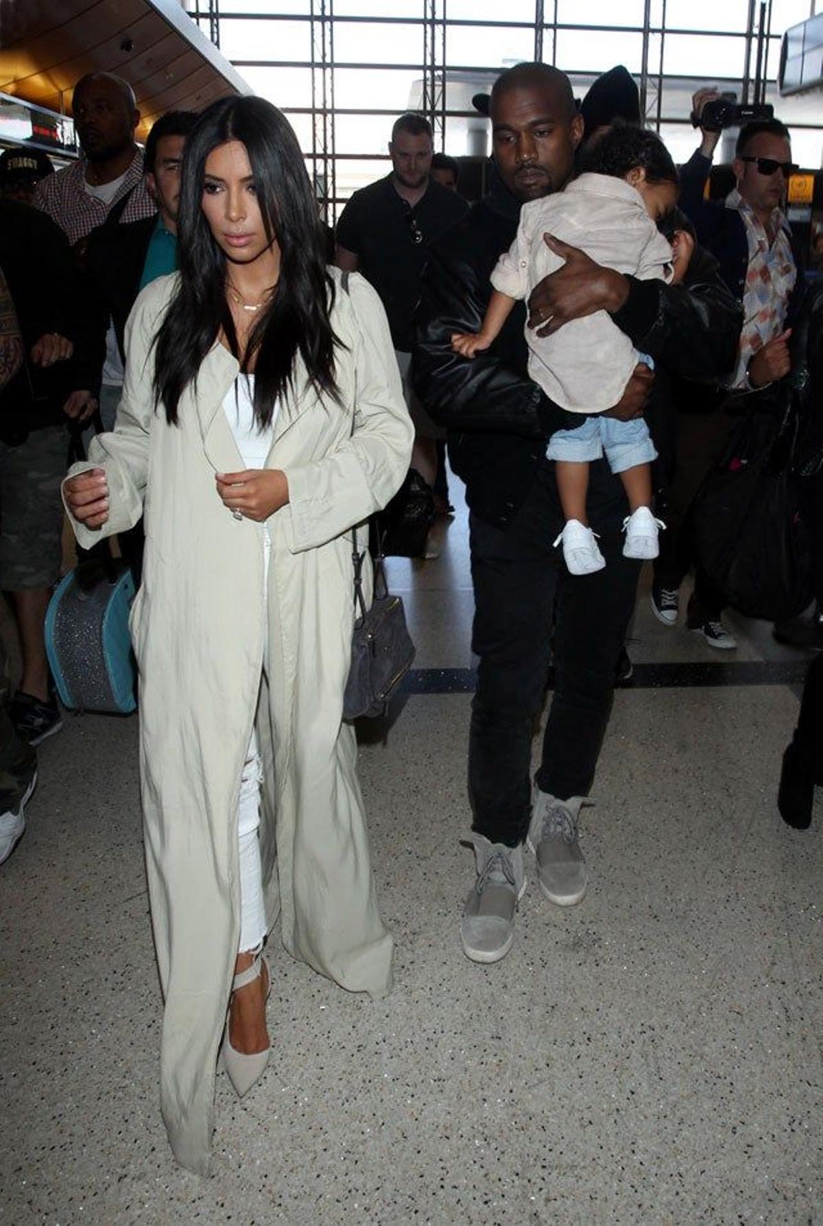 Kim Kardashian camina por delante de Kanye West entre una nube de periodistas