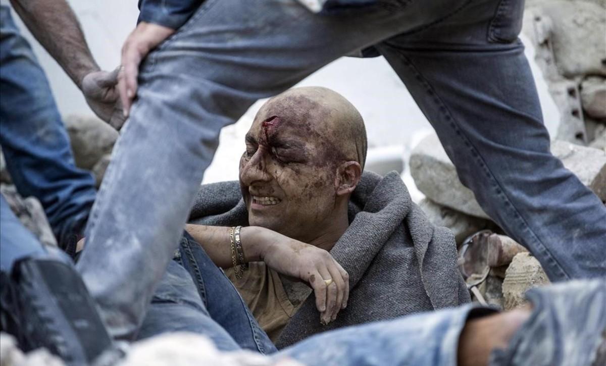 jjubierre35274276 a man is pulled out of the rubble following an earthquake in160824102834