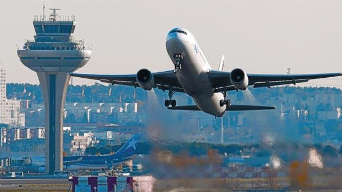 Despegue frente a la torre de control del aeropuerto madrileño de Barajas, ayer.