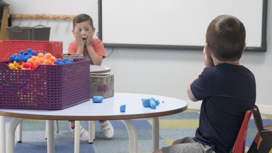 Nens fan broma en una classe, mantenint distància