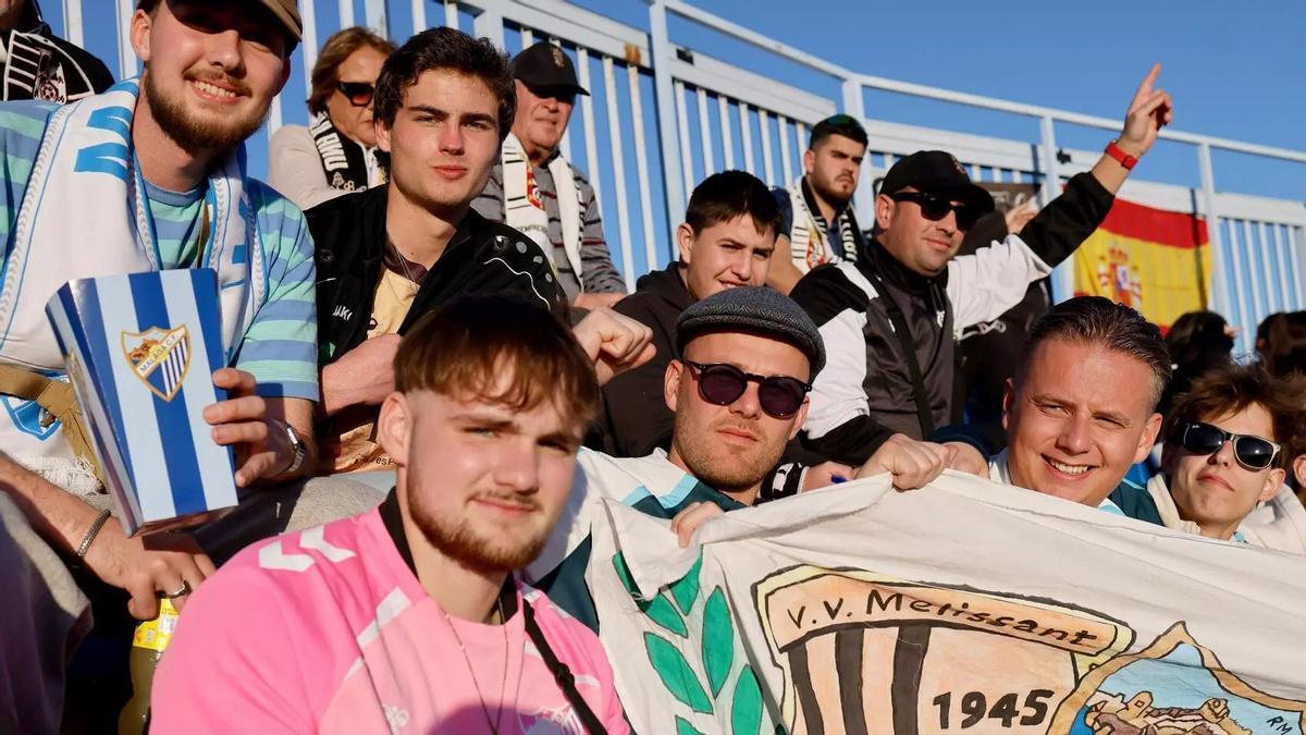 Miembros del Melissant neerlandés en las gradas de La Rosaleda durante el Málaga CF - AD Ceuta.