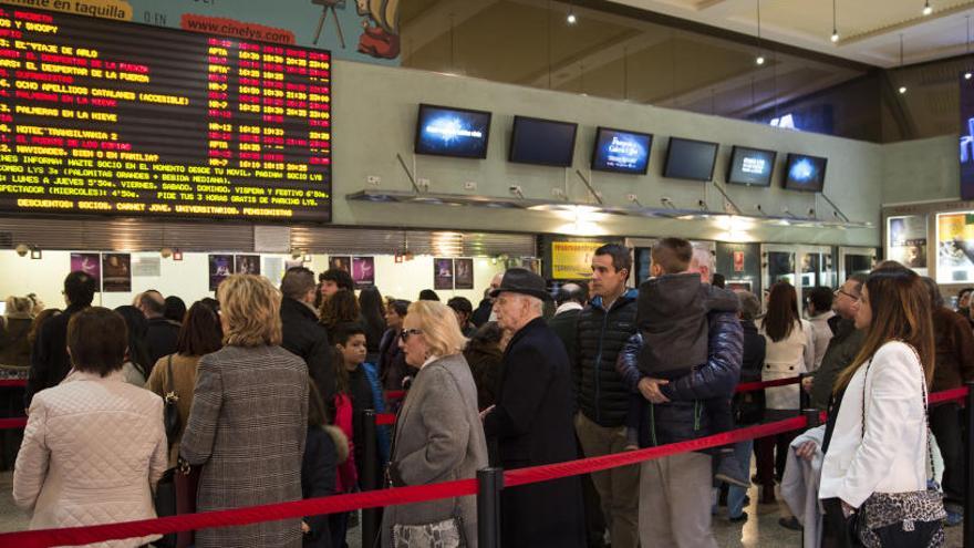 Gent fent cua per entrar a una sala de cine.