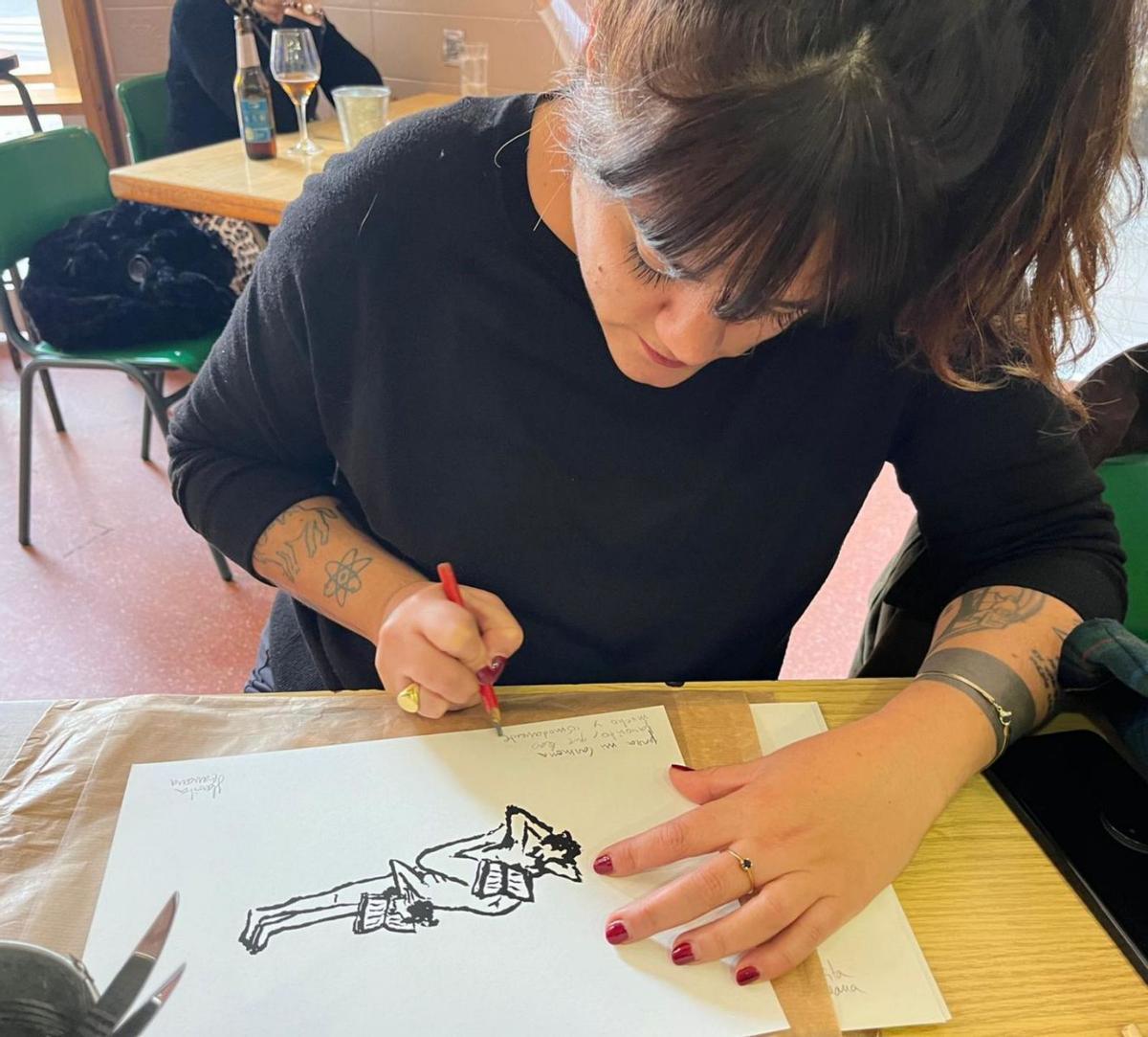 La popular ilustradora y viñetista dedica en una cafetería una de sus obras. | ÁNGEL CARMONA