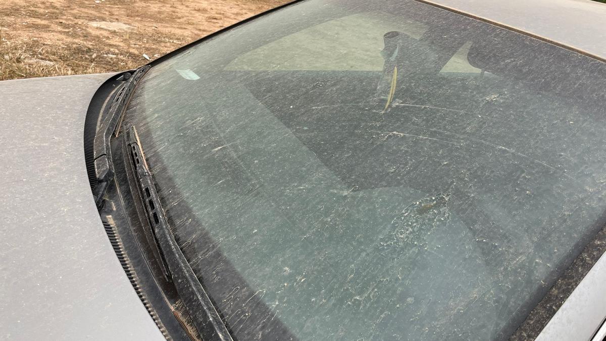 Un coche cubierto de barro tras la lluvia en Valencia.