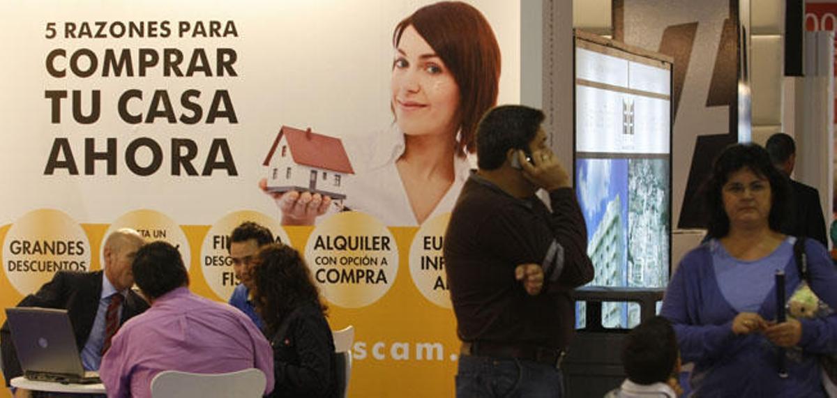 Clientes consultan una promoción de viviendas en Málaga.