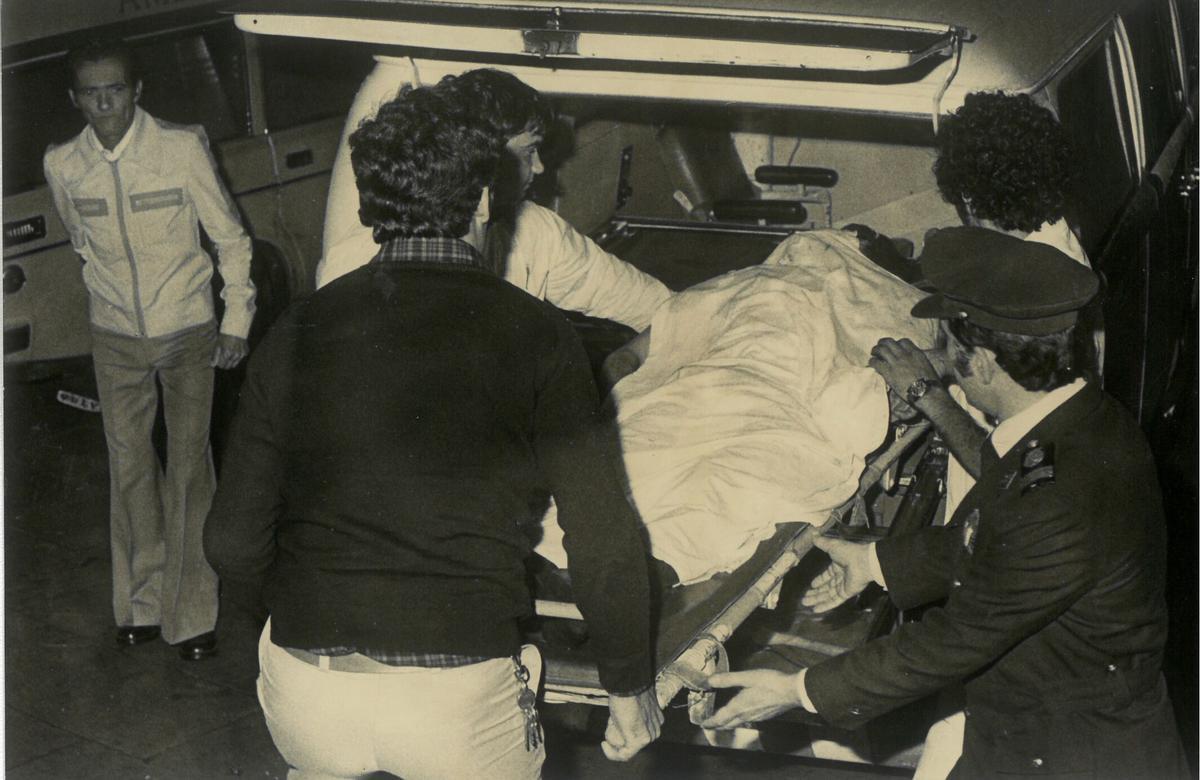 Sanitarios introducen el cadáver de una de las víctimas en una ambulancia, la trágica tarde del 4 de enero de 1979