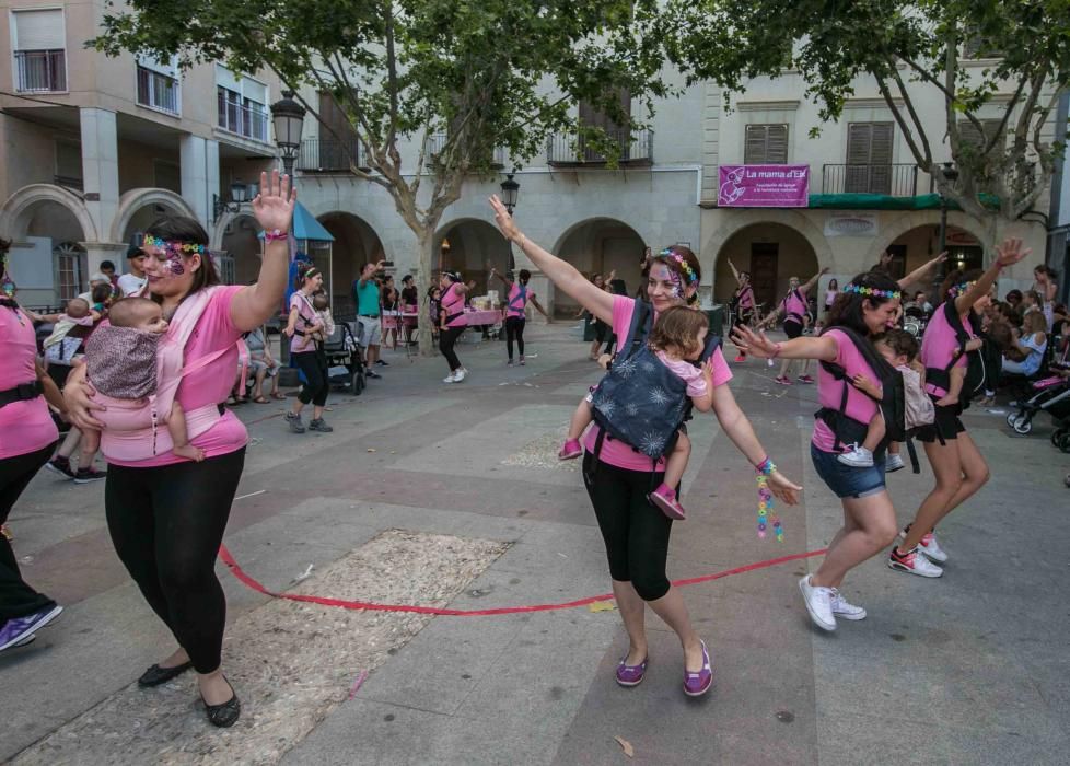 Un grupo de madres representa la canción central del musical «Mamma Mia» en la plaza de El Raval porteando a sus bebés