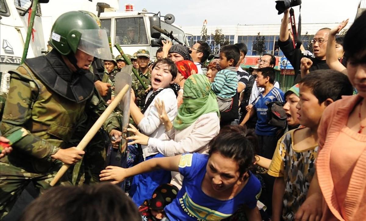 undefined10906824 ethnic uygur women  r  clash with chinese riot police as the180813134214