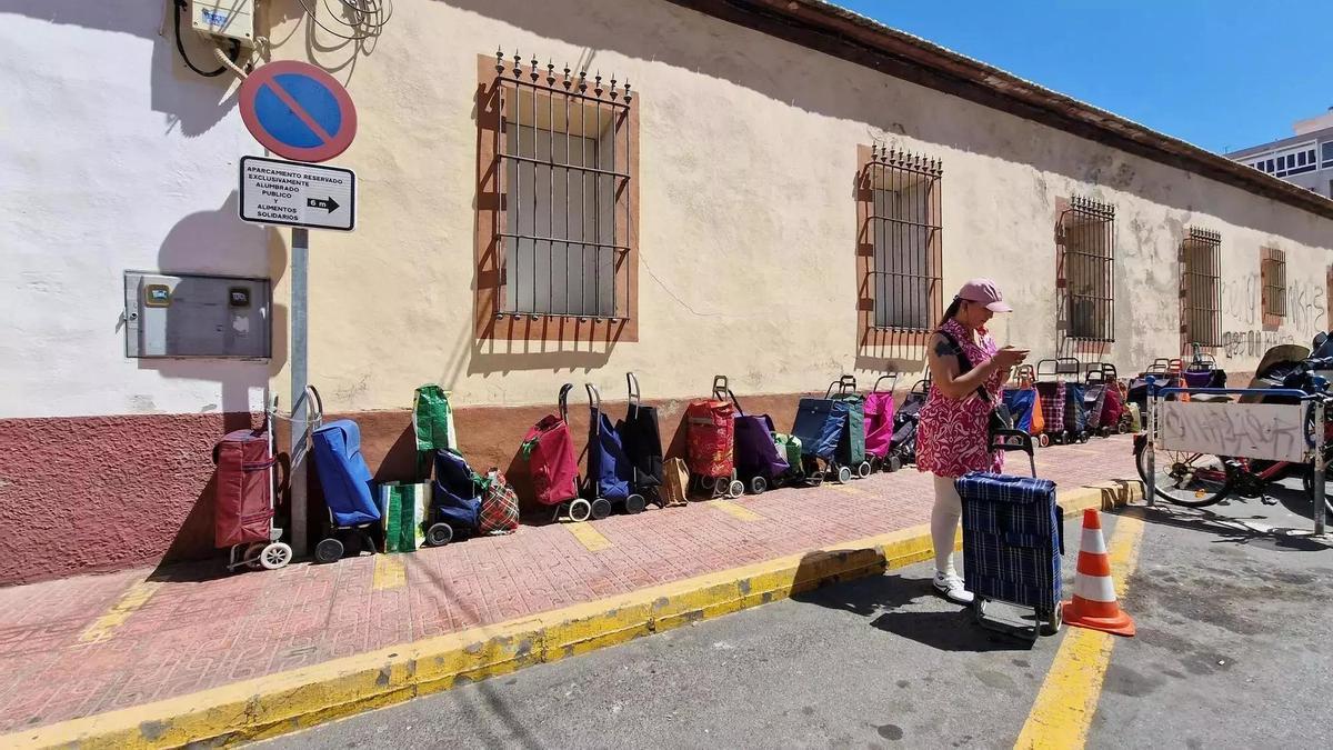 Carros situados para guardar el turno en el catering social de Alimentos Solidarios en Torrevieja que garantiza comida diaria a unas 200 familias