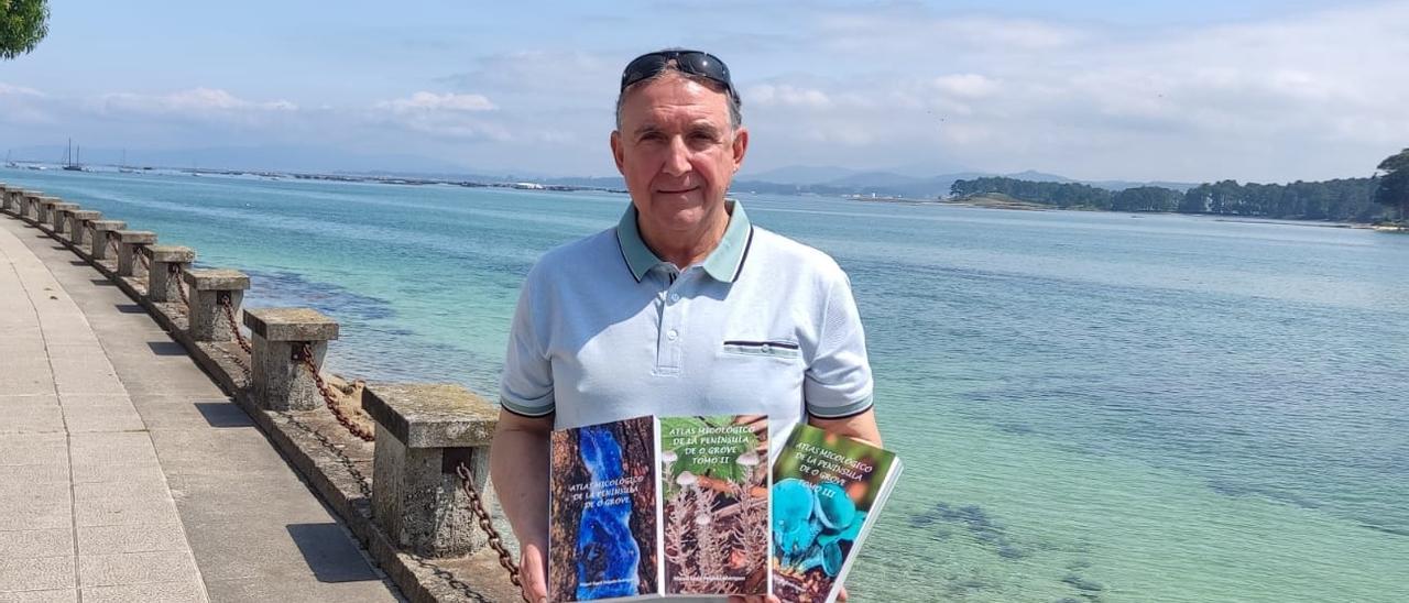 Miguel Ángel Delgado posa en el paseo marítimo de Beiramar con los tres volúmenes del “Atlas Micológico Península de O Grove”.