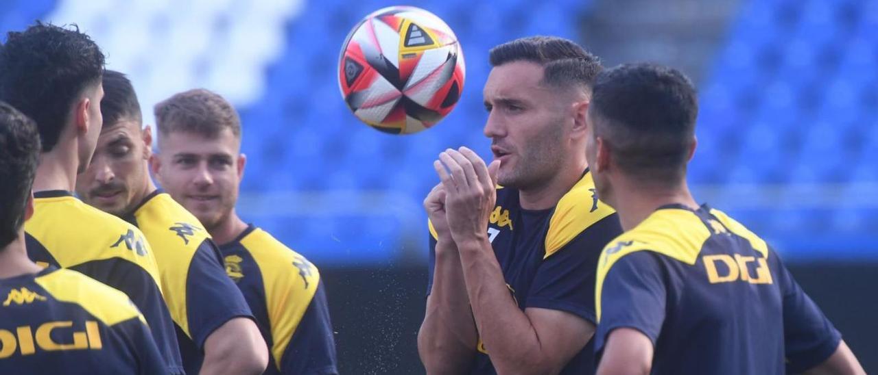 Lucas Pérez se protege de un balón en el entrenamiento de ayer en Riazor. |  // CARLOS PARDELLAS