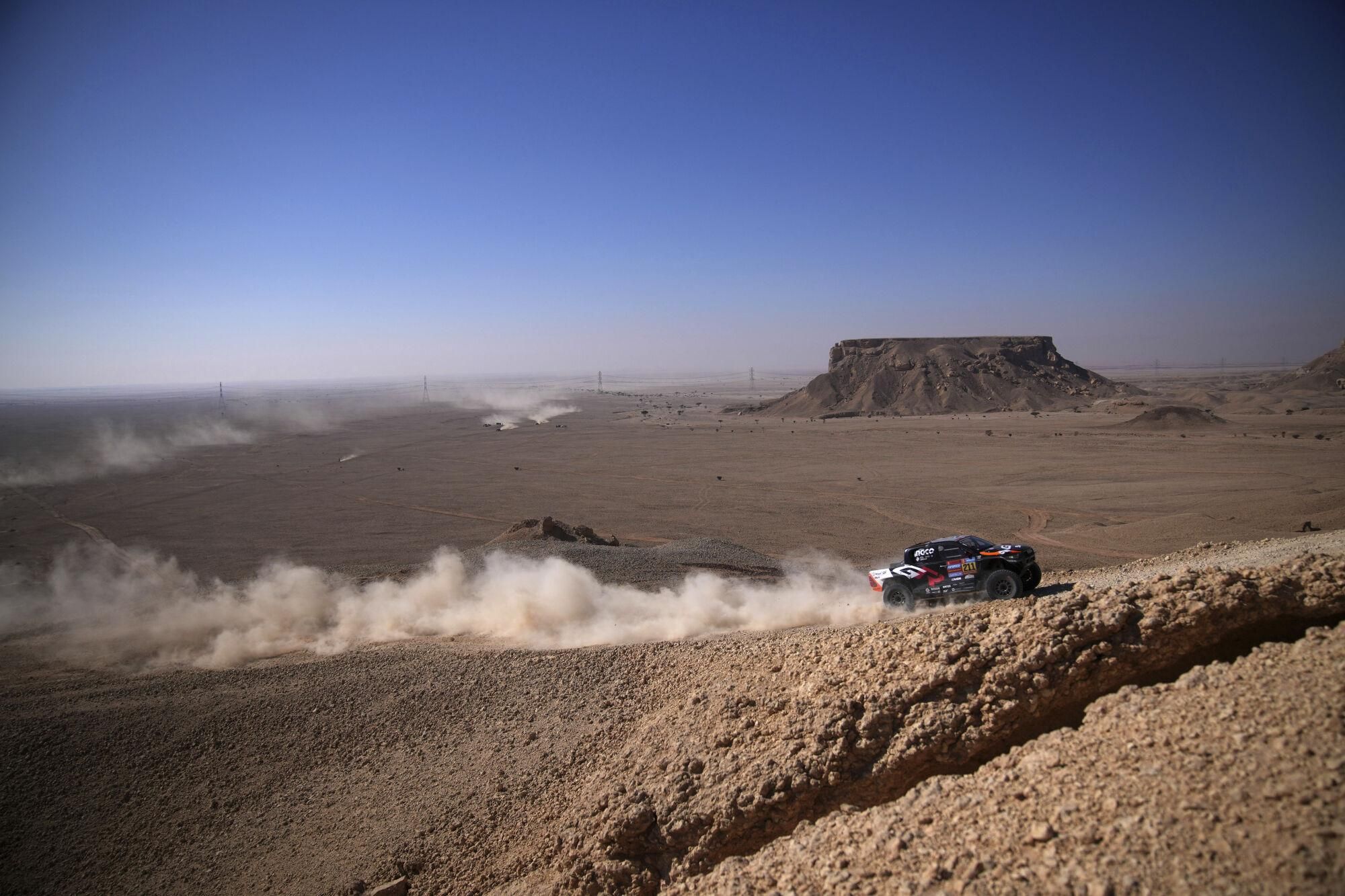 Driver Henk Lategan and co-driver Brett Cummings compete during the ninth stage of the Dakar Rally between Riyadh and Haradh, Saudi Arabia, Tuesday, Jan. 14, 2025. (AP Photo/Christophe Ena)