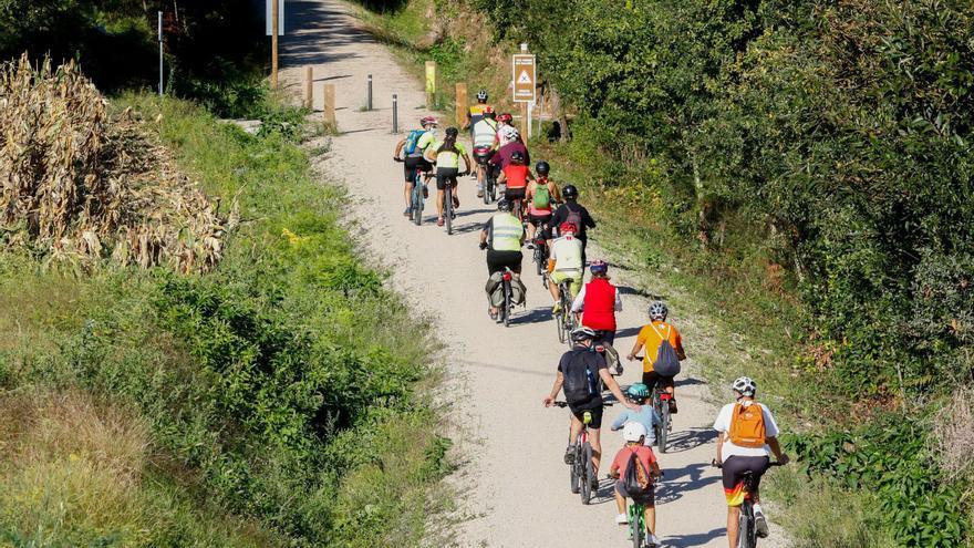 Un grupo de ciclistas realiza su recorrido por la vía verde entre Rubiáns y la vieja estación de Portas. |  // IÑAKI ABELLA
