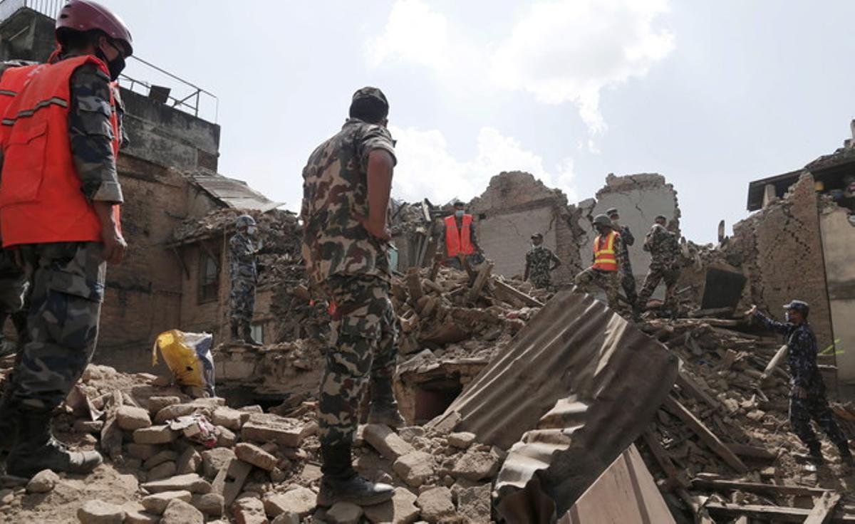 Soldats i equips de rescat nepalesos busquen supervivents entre la runa dels edificis caiguts després del terratrèmol.