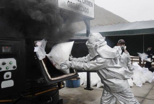 Anti-narcotics officers burn bags of  the cocaine seized last week near Trujillo, in Lima