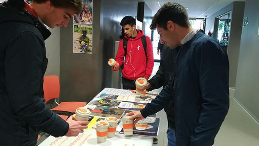 Alumnos del CEU compran vasos solidarios contra la violencia hacia las mujeres.