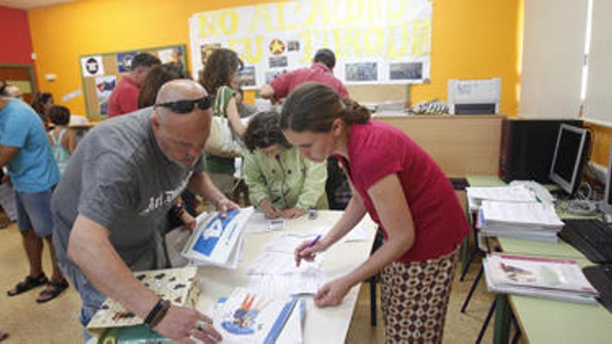 Padres devolviendo los manuales de sus hijos para crear el banco de libros de XarxaLlibres.