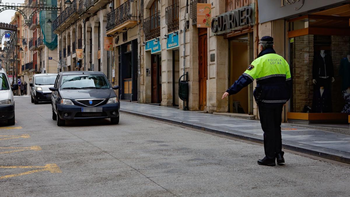 Un policía local dando el alto a un vehículo en la zona acotada.