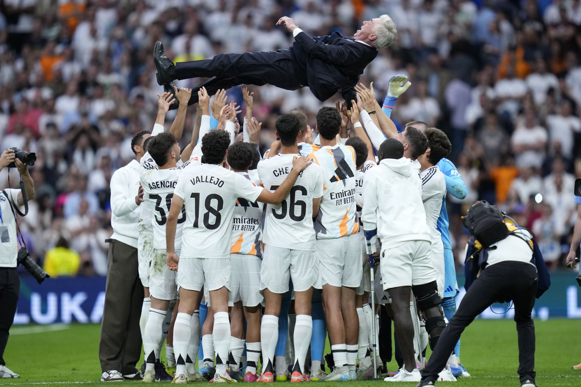 Real Madrid's head coach Carlo Ancelotti is lifted in the air by the players after a Spanish La Liga soccer match against Real Sociedad at Santiago Bernabeu stadium in Madrid, Saturday, May 24, 2025. (AP Photo/Cesar Cebolla)