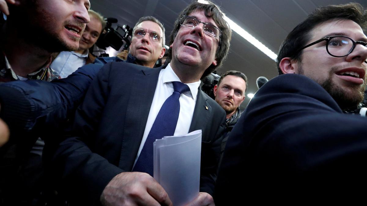 Sacked Catalan leader Carles Puigdemont departs after a news conference in Brussels