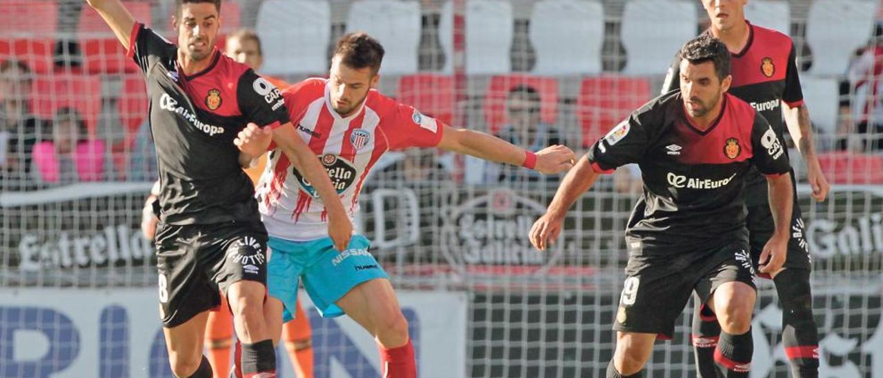 Juan Domínguez conduce el balón ante la presión de un rival y la mirada de Culio en el partido del sábado en Lugo.