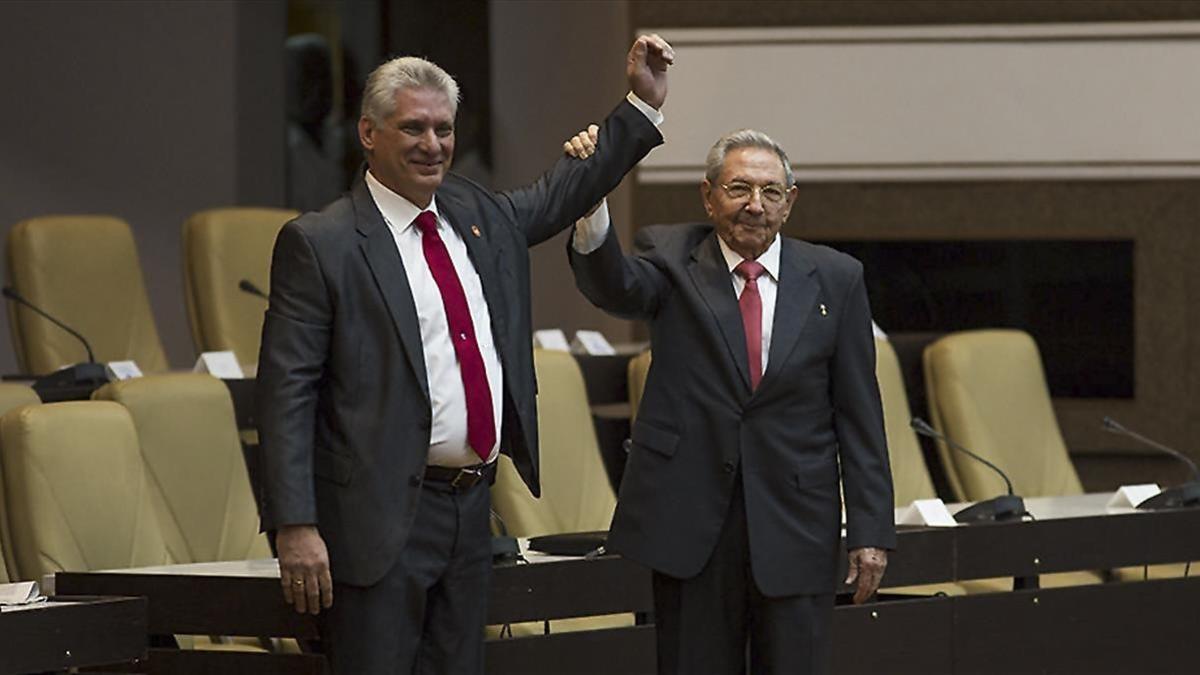 Raúl Castro (derecha) levanta el brazo del nuevo presidente de Cuba, tras ser nombrado oficialmente por la Asamblea Nacional, en La Habana, el 19 de abril.