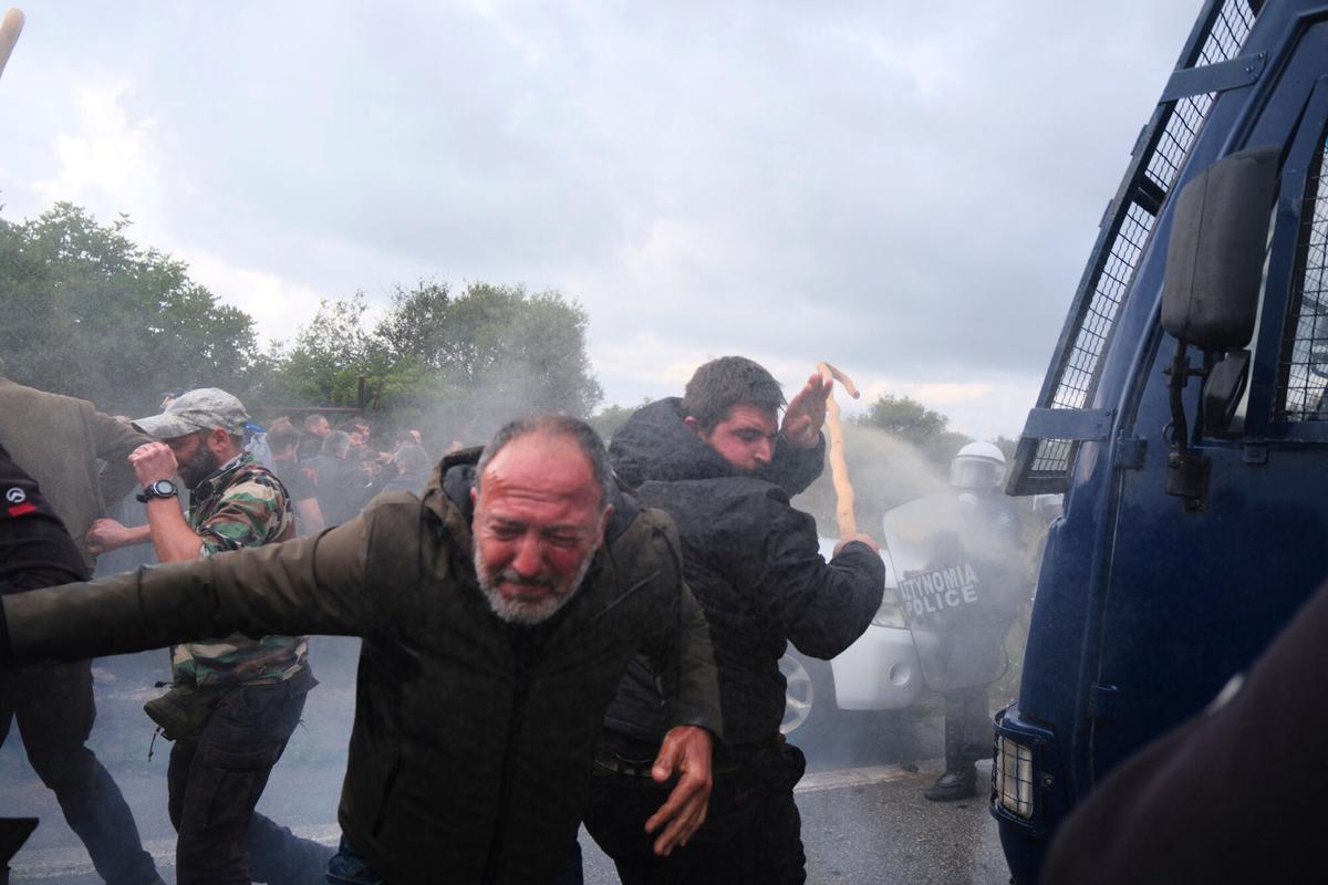 Police use tear gas against farmers during clashes with officers blocking their march to Chanias airport on Crete, Greece, Monday, Dec. 8, 2025, amid protests over delayed EU farm subsidies. (AP Photo/Giannis Angelakis)