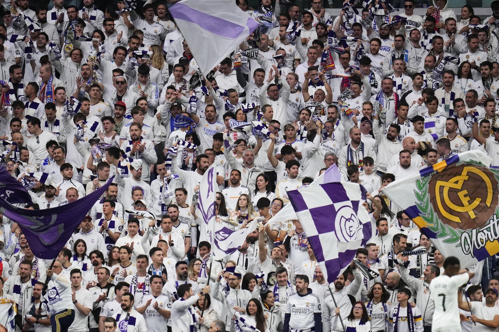 Real Madrid's fans support their team during the Spanish La Liga soccer match between Real Madrid and Girona at the Santiago Bernabeu stadium in Madrid, Spain, Sunday, Feb. 23, 2025. (AP Photo/Manu Fernandez)