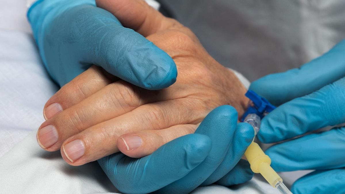 Un médico cierra la cánula de un paciente.