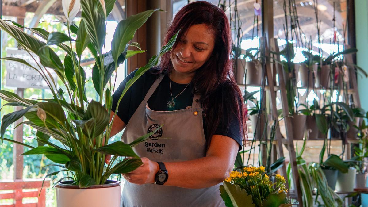 Treballadora de Garden Ampans arreglant una planta