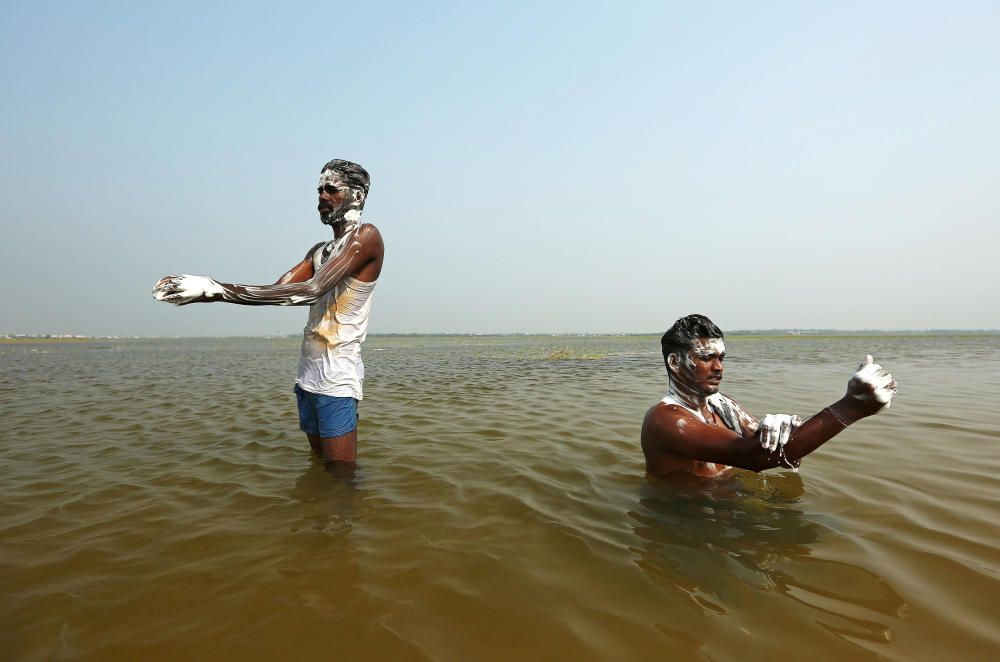 Men bathe in the waters of Puzhal lake on the ...