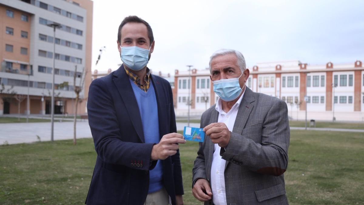 Luis Verde y José del Río con la tarjeta de transporte para desempleados.