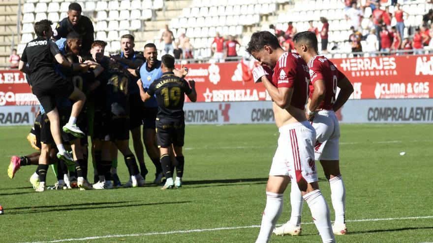 Los jugadores del Real Murcia, decepcionados, mientras los del Castellón celebran su paso definitivo hacia el ascenso. | ISRAEL SÁNCHEZ