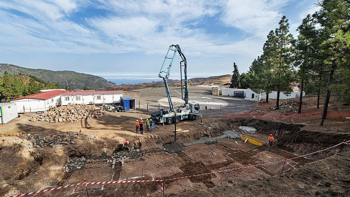 Varios trabajadores en una obra de urbanización de un solar.
