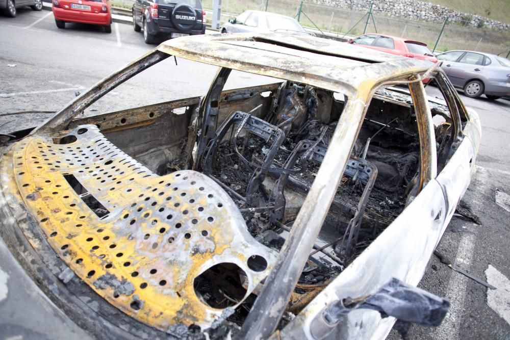Coche quemado en un aparcamiento en Sama, Langreo